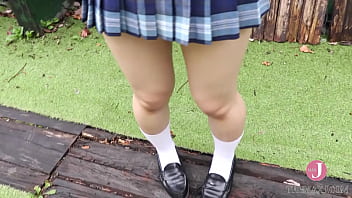 Innocent Japanese petite in schoolgirl costume shows off her body on camera