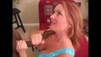 Sexy red head strokes a black dick
