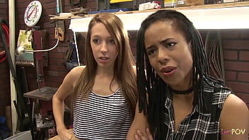 Interracial lesbian sex between two cute girls in a workshop next to the power tools